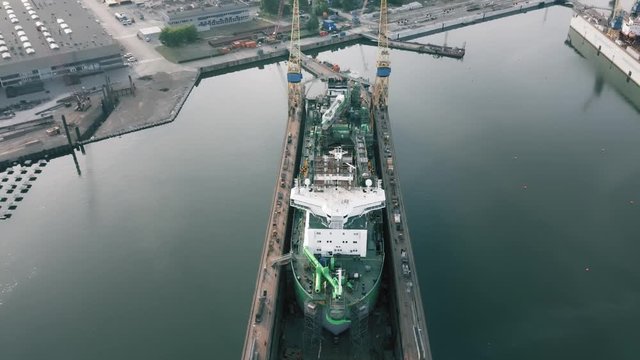 Ship being built or repaired in shipyard, construction site, aerial view
