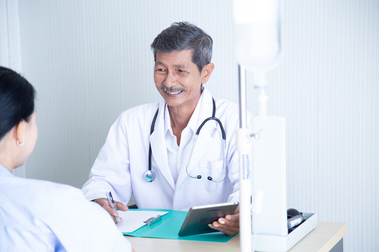 Senior male doctor smile discussing with  speaking with his senior patient