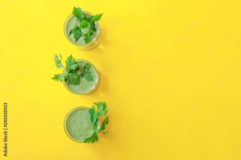 Glasses of healthy smoothie on color background