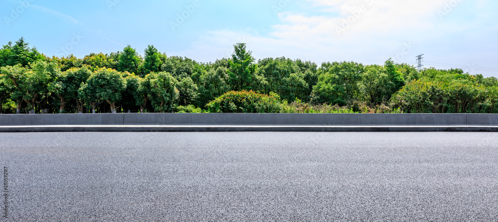 Asphalt highway and green forest with beautiful clouds landscape