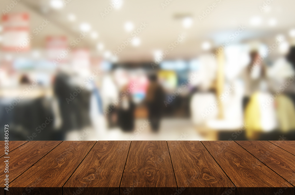 Wood table in shopping mall or department store blur background with empty copy space on the table f