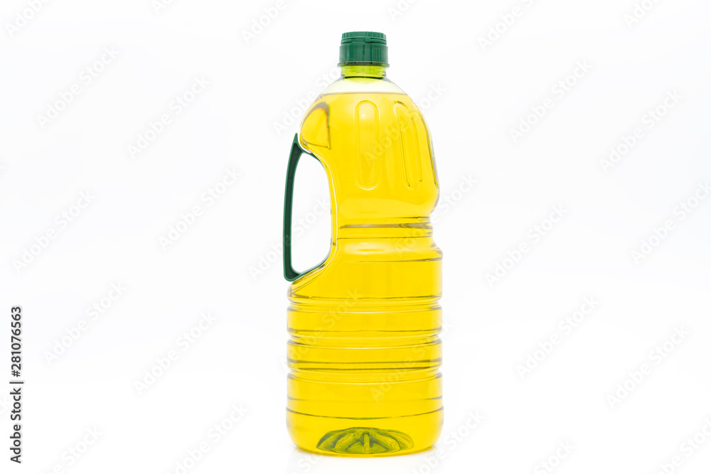 A bottle of yellow salad oil on a white background