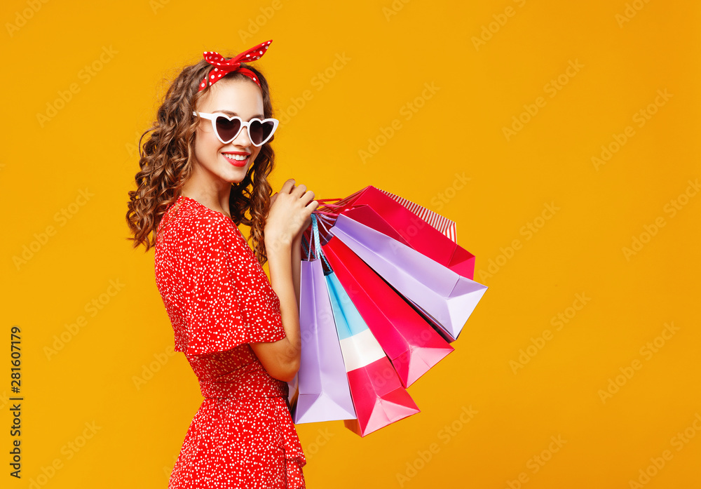 黄色背景的快乐女孩的购物购买和销售概念。