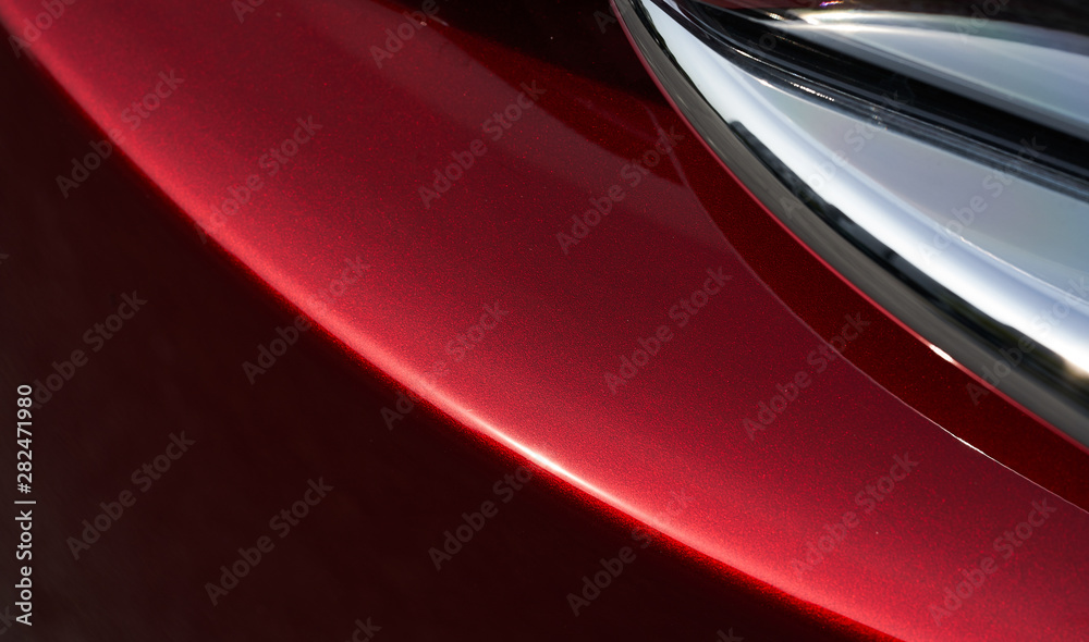 Close up detail of red metallic paint coating car body