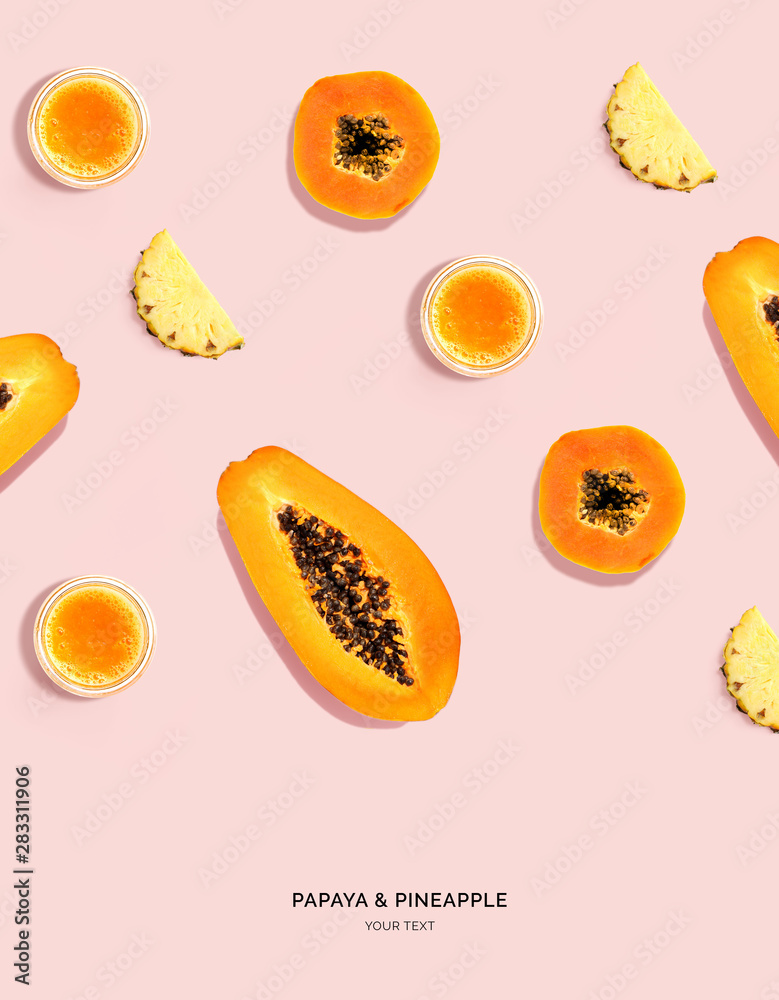 由木瓜、木瓜汁和菠萝在粉色背景上制成的创意布局。平躺。食物概念