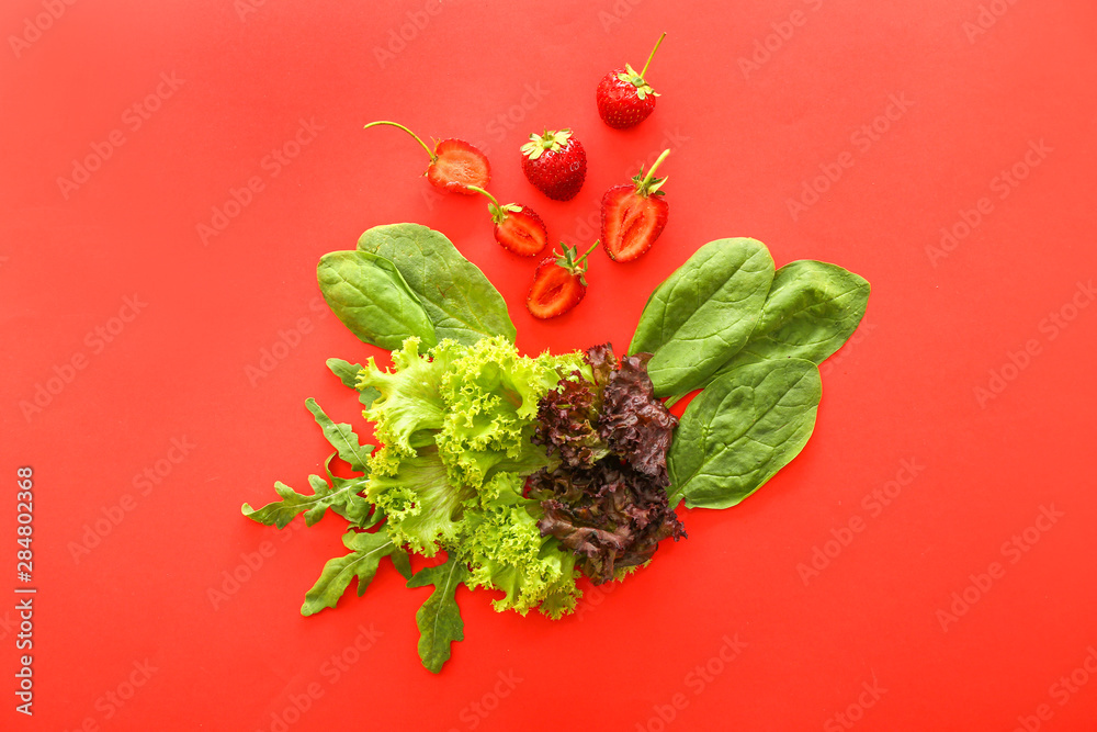 Fresh strawberry with herbs on color background