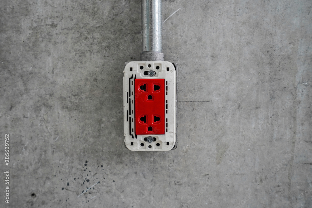 Red Plug socket On Concrete Wall