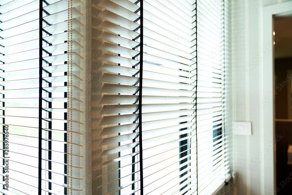 white window shutter blind with light from sun home interior concept