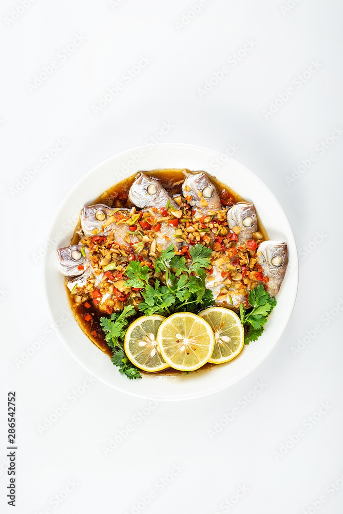 Chinese dish of hot chilli steamed red squid on white background