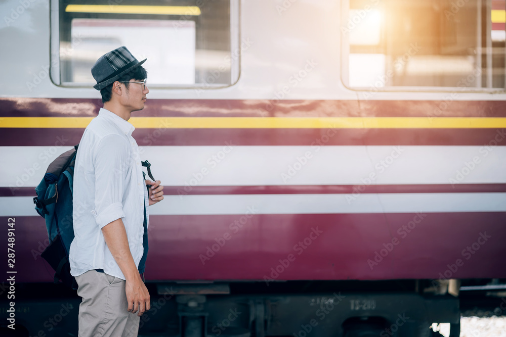 亚洲人是旅行者，他在等他们的火车。户外冒险旅行的火车概念。禁止