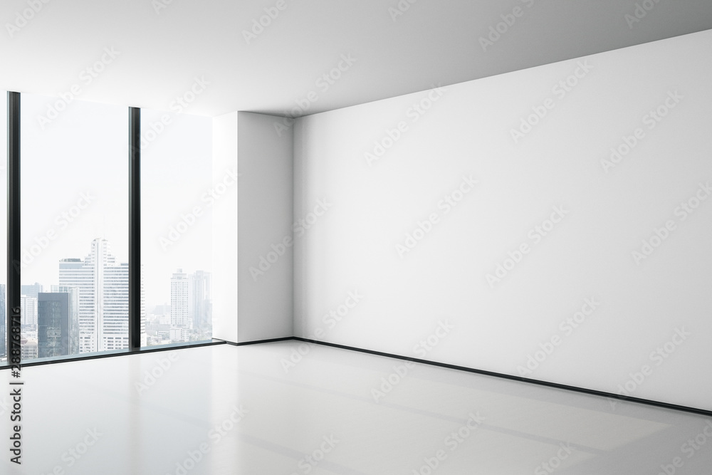 空荡荡的现代办公大厅里的白色实体墙，有大窗户和城市景观。