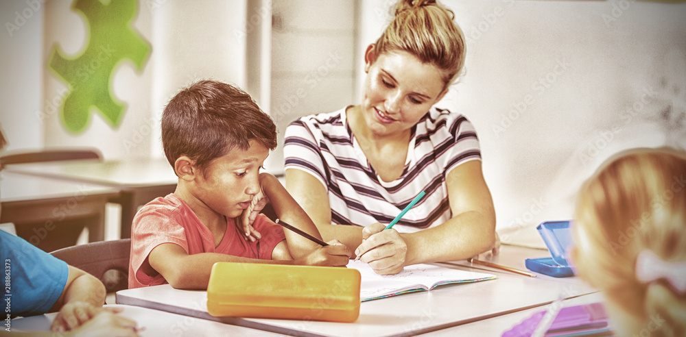 Teacher helping kids with their homework in classroom