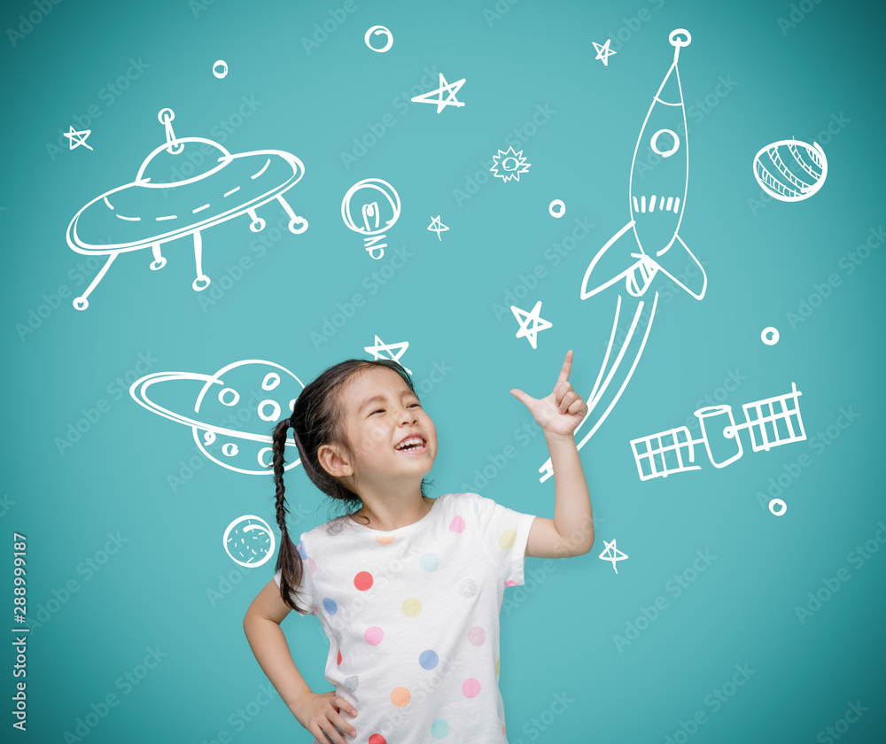 Asian child girl pointing at the blackboard with imagination the astronaut and space rocket, Creativ