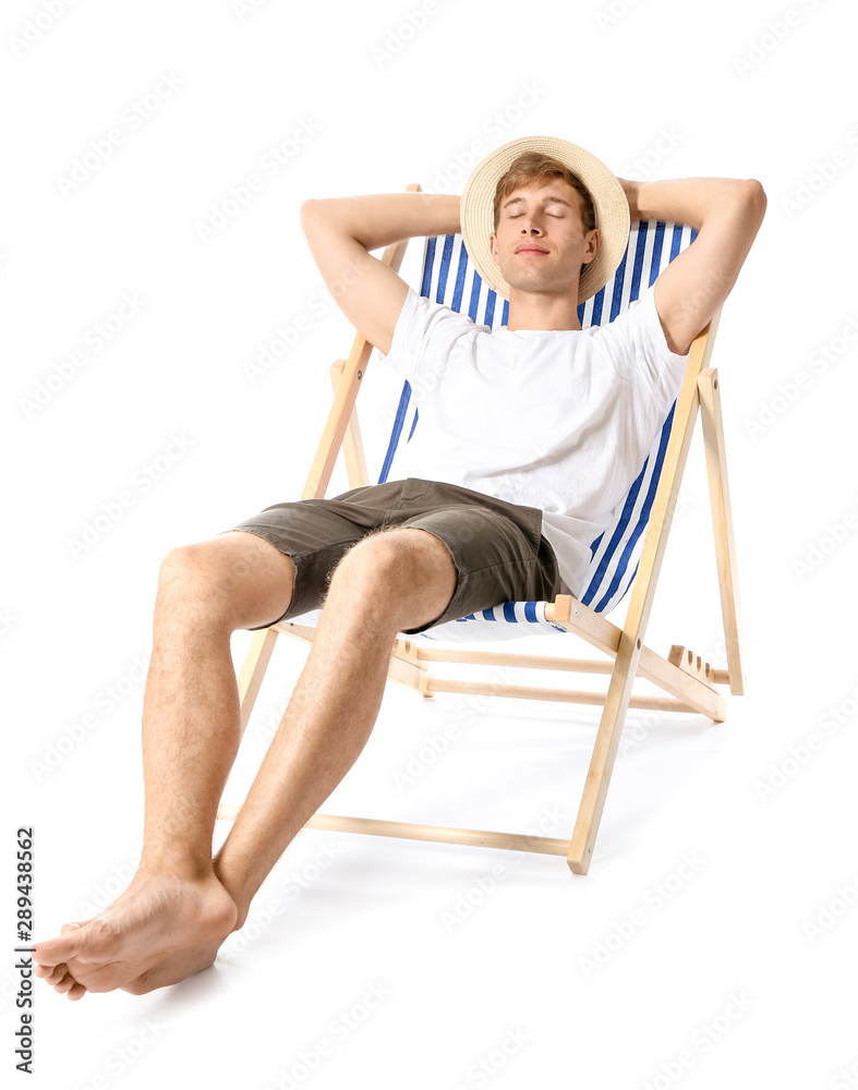 Young man relaxing on sun lounger against white background