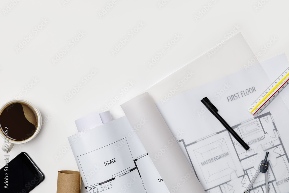 Creative flat lay of architects white table with roll blueprints, architectural project plan, engine