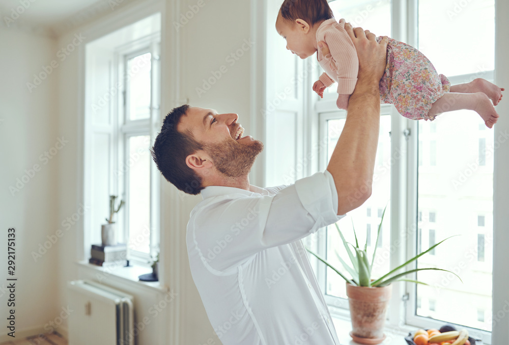 慈爱的父亲将他的女婴举在空中