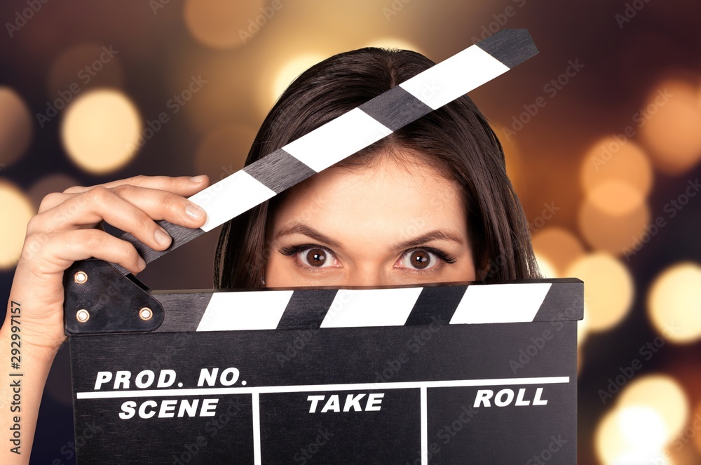 Young woman with movie clapper isolated