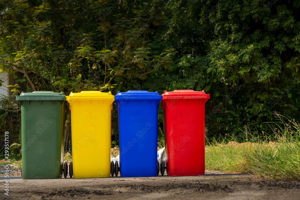 Trash bin standing on industrial site,Trash bin color red,blue,yellow with green and black paint on 
