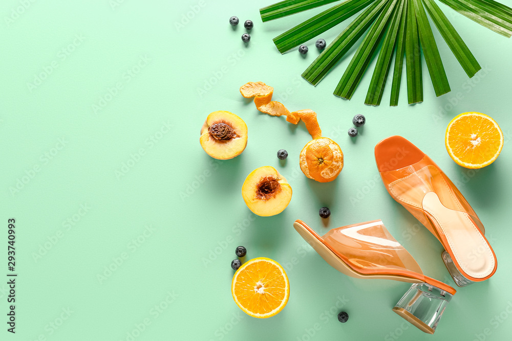 Summer composition with female shoes and fruits on color background