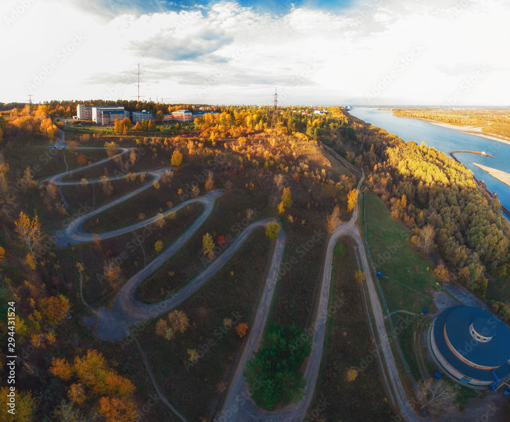 城市蜿蜒道路的空中俯视图，无人机拍摄。俄罗斯西伯利亚巴瑙尔。美丽的秋日
