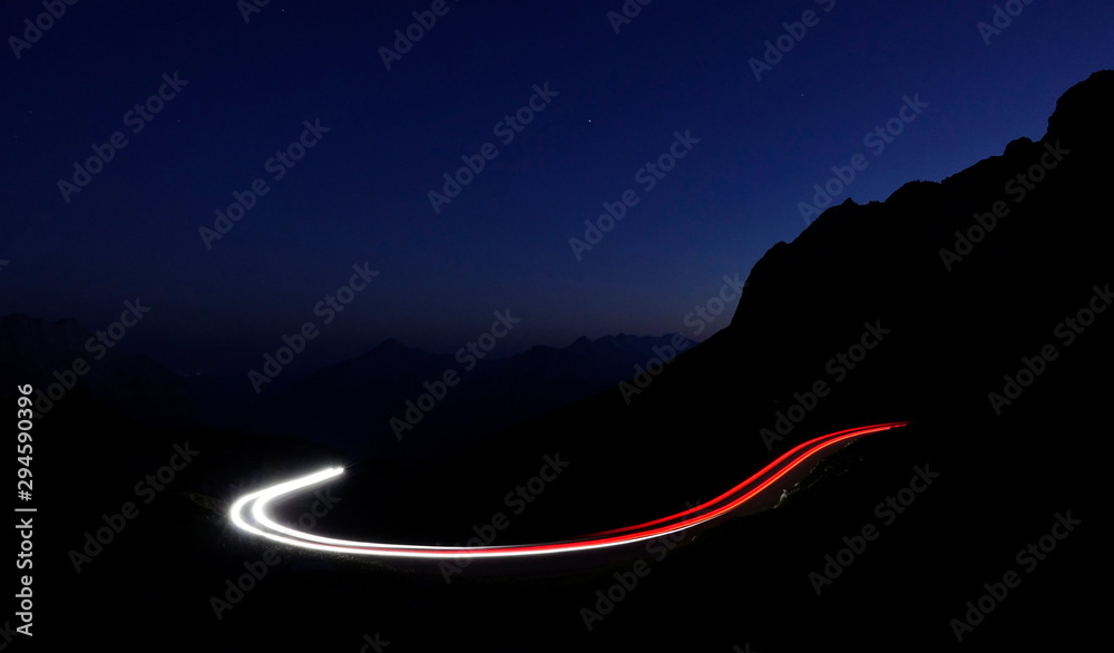 TIMELAPSE: Cars driving down the mountain road create trails with their lights
