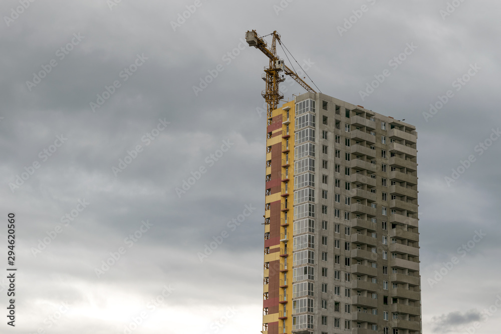 Building under construction. Lifting crane