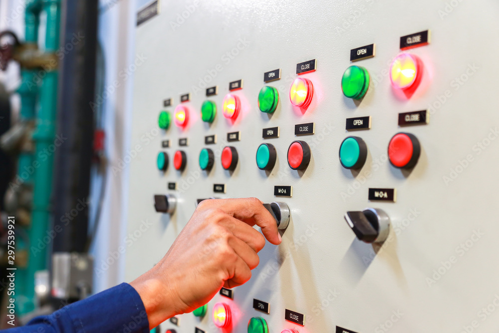 industrial technician check voltage or current status in control panel of power plant.