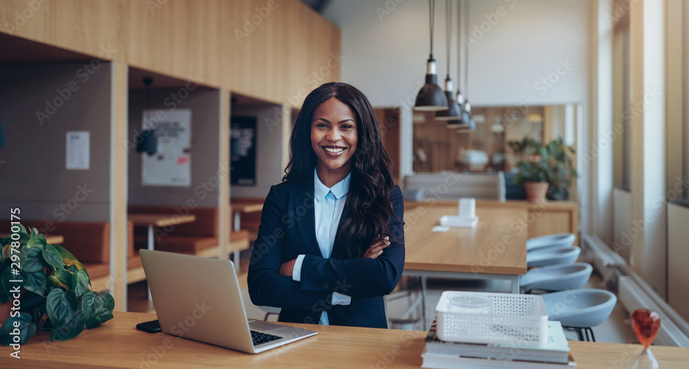 Smiling African American woman standing in an office lounge