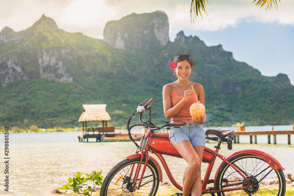 E-bike tourist travel woman biking on electric bicycle rental in Bora Bora, French Polynesia Tahiti 
