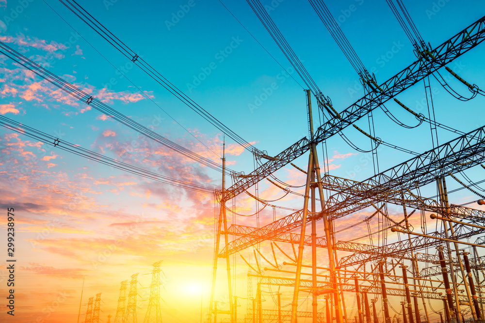 High voltage electricity tower at sunset.substation industrial background.