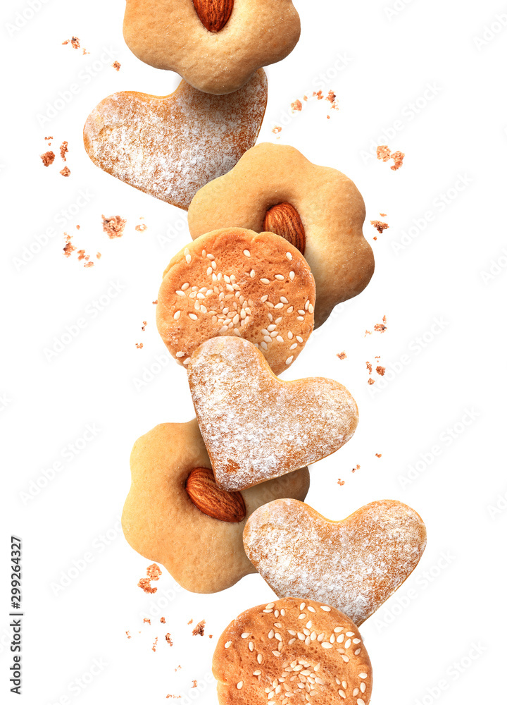 Falling tasty cookies on white background