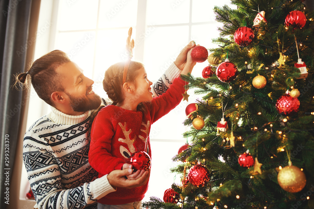 happy family father and child girl decorated Christmas tree