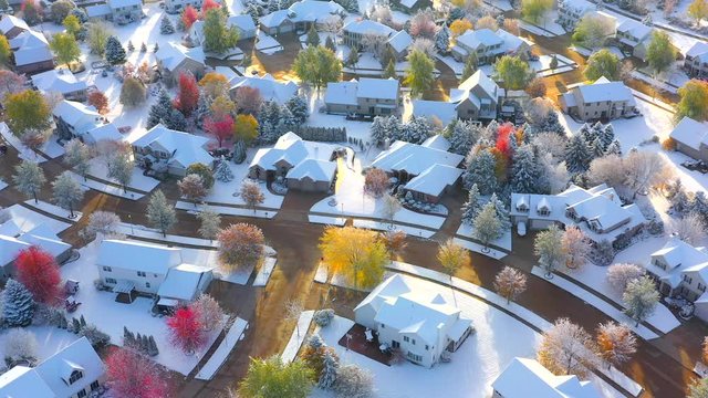 Beautiful neighborhoods, homes, Fall colors, at the magical point where Autumn meets Winter; first snow on Fall colors, colorful trees, aerial drone view.