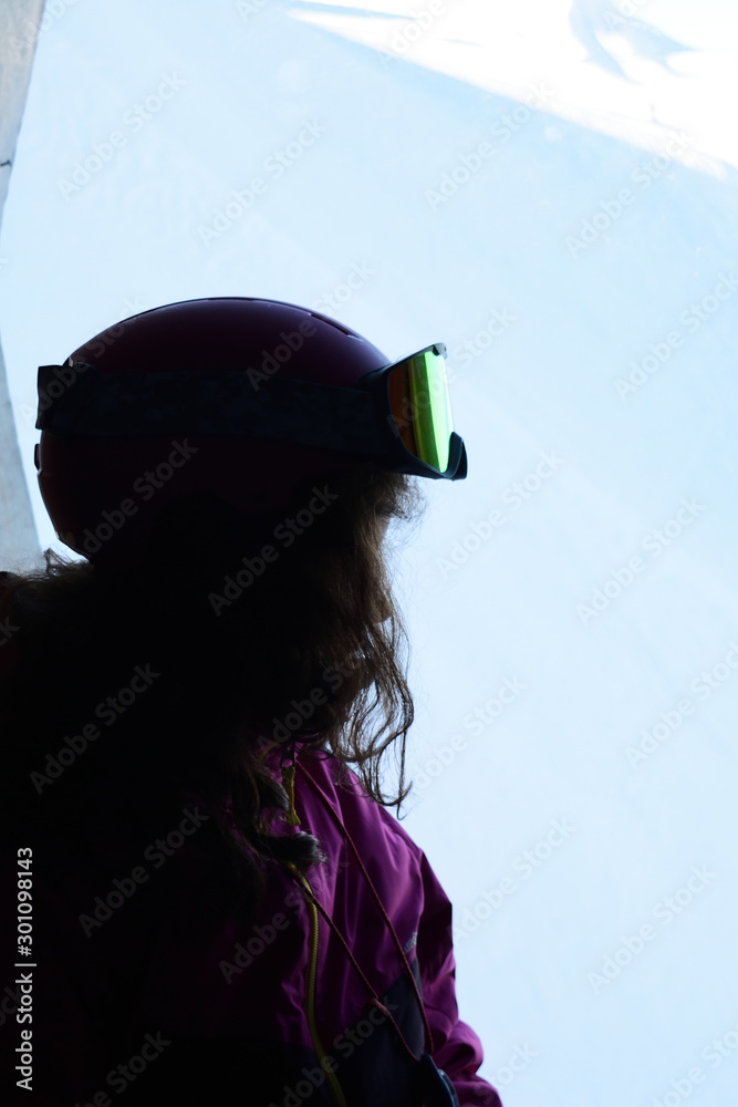 silhouette of young woman equipped for skiing