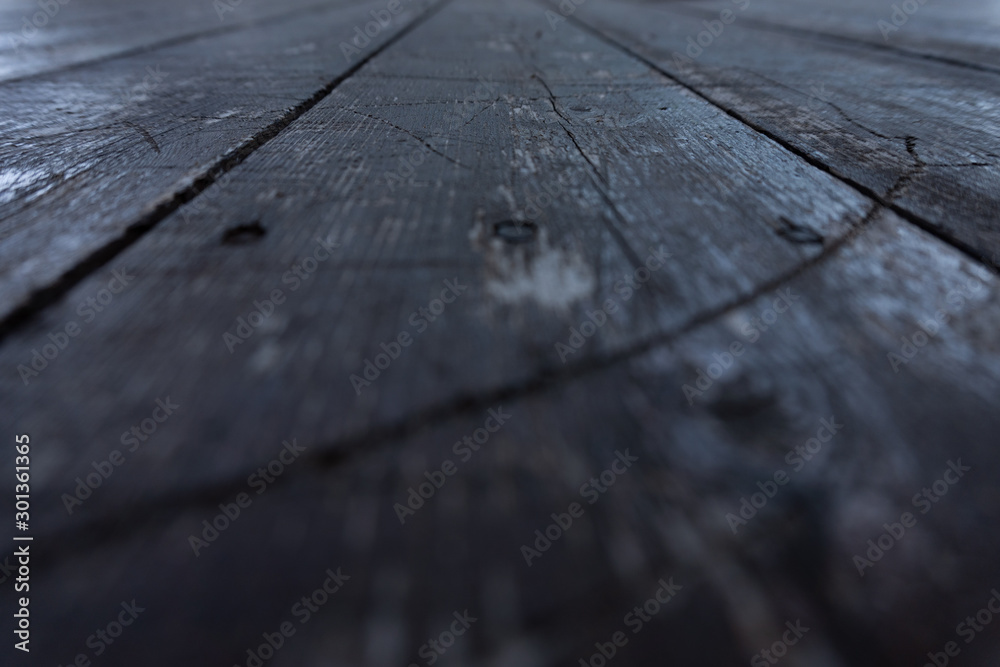 Close up of an old black wooden table