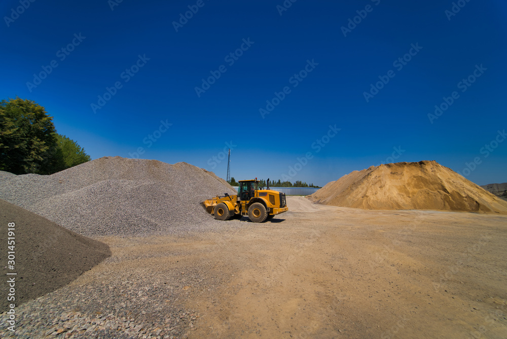 Quarry aggregate with heavy duty machinery. Construction industry. Horizontal