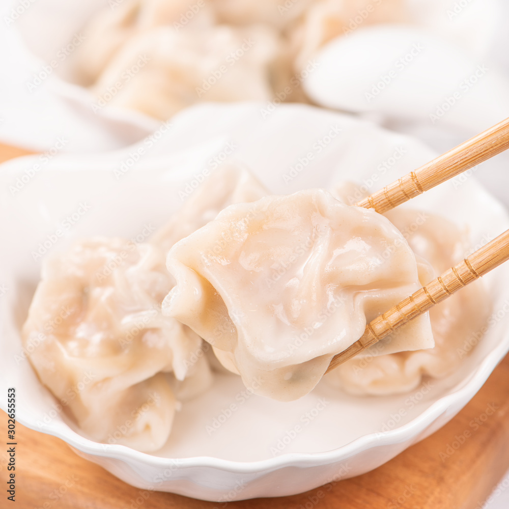 Fresh, delicious boiled pork, shrimp gyoza dumplings on white background with soy sauce and chopstic