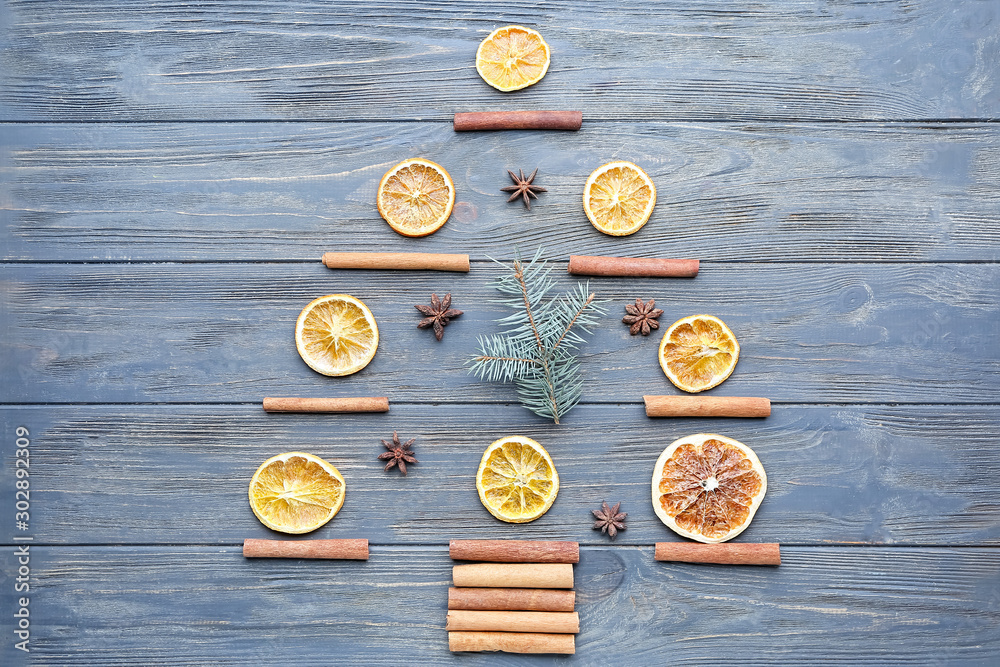 Christmas tree shape made of spices on wooden background