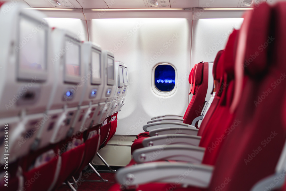 Empty passenger seat in an airplane in red