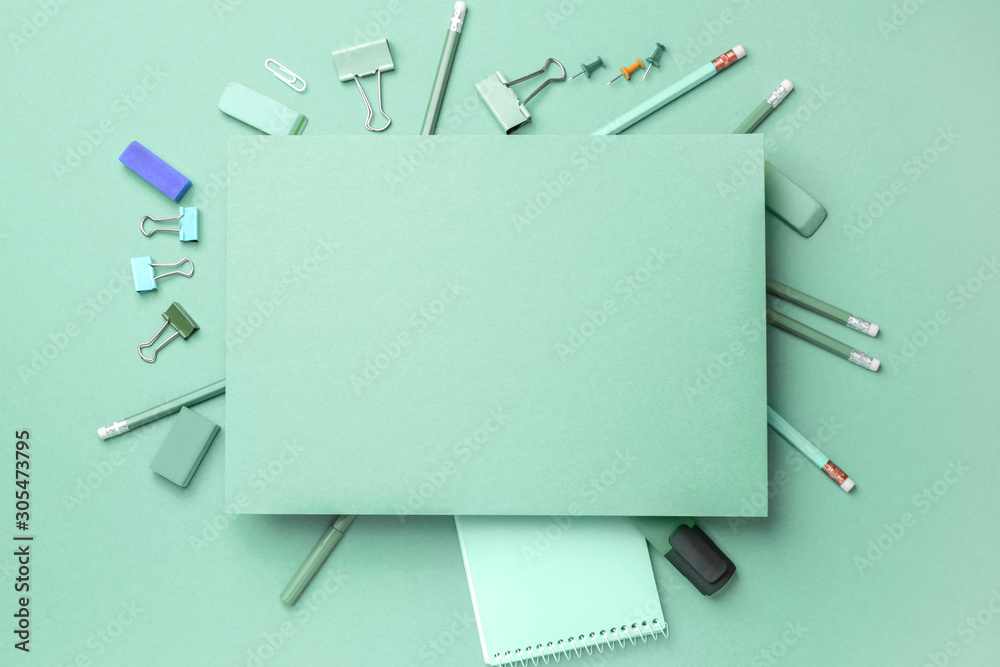 Blank paper sheet and stationery on turquoise background