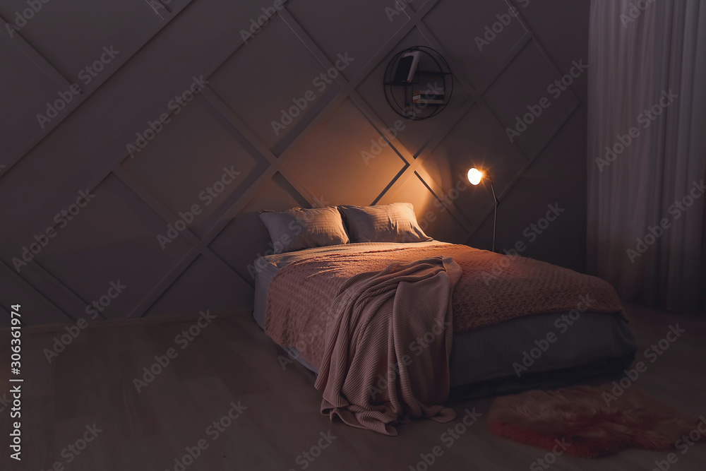 Stylish interior of bedroom at night
