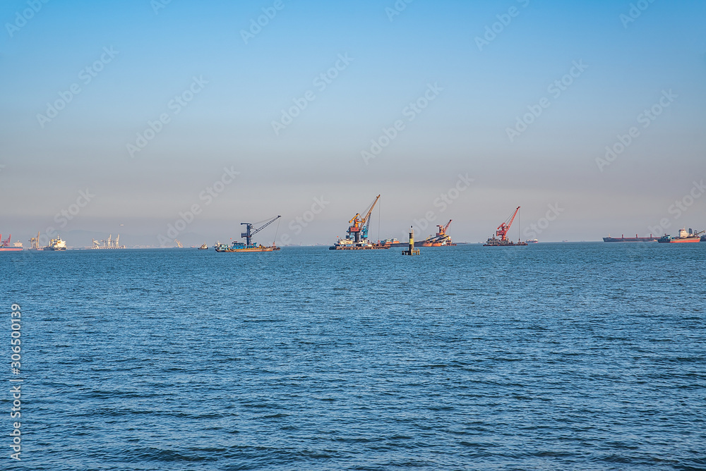 中国广东珠江口附近的浮吊和集装箱船