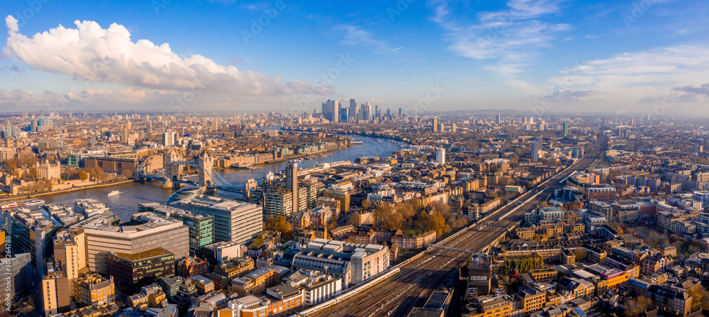 Panoramic aerial view of London, UK. Beautiful skyscrapers, river Thames and railway going through t