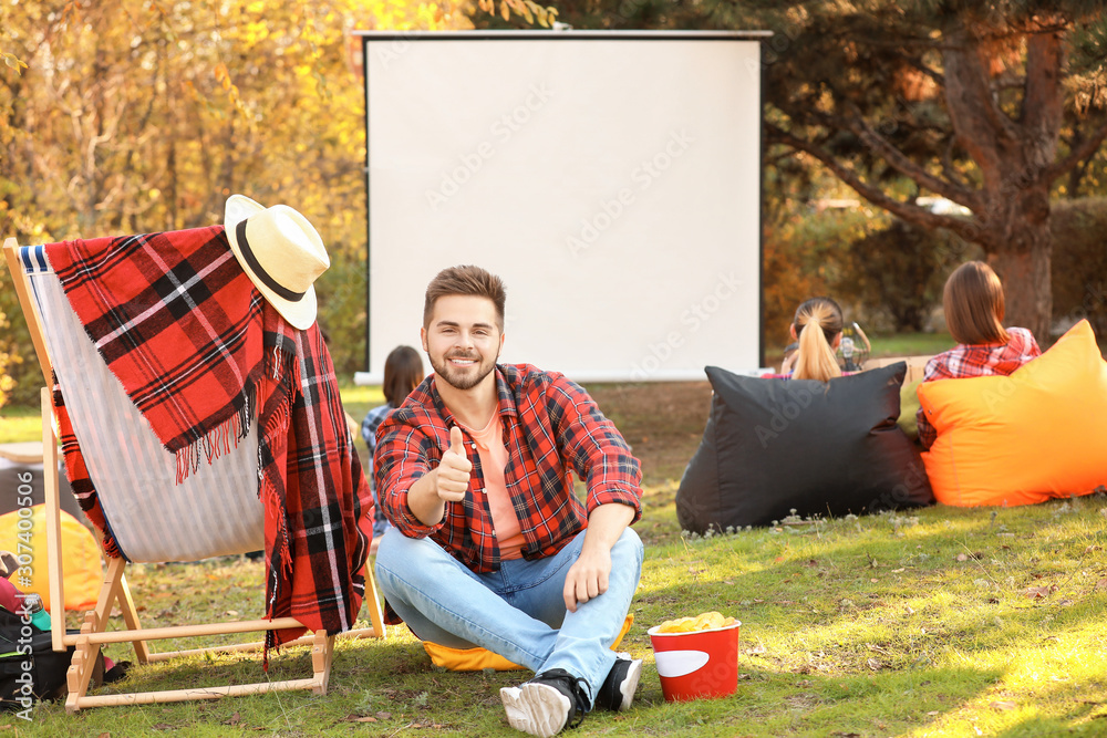 Young man in outdoor cinema