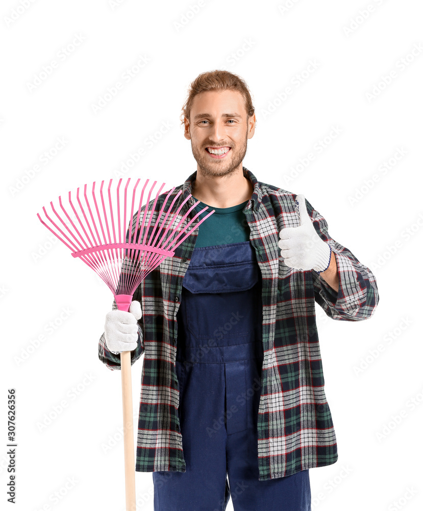 Man with rake for autumn leaves clean-up showing thumb-up on white background
