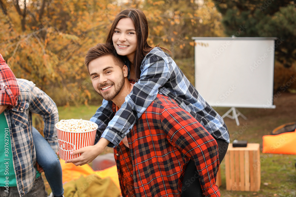 Young couple having fun in outdoor cinema
