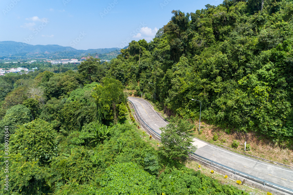 Aerial view drone shot of Asphalt road curve on mountain tropical rainforest Bird eye view.