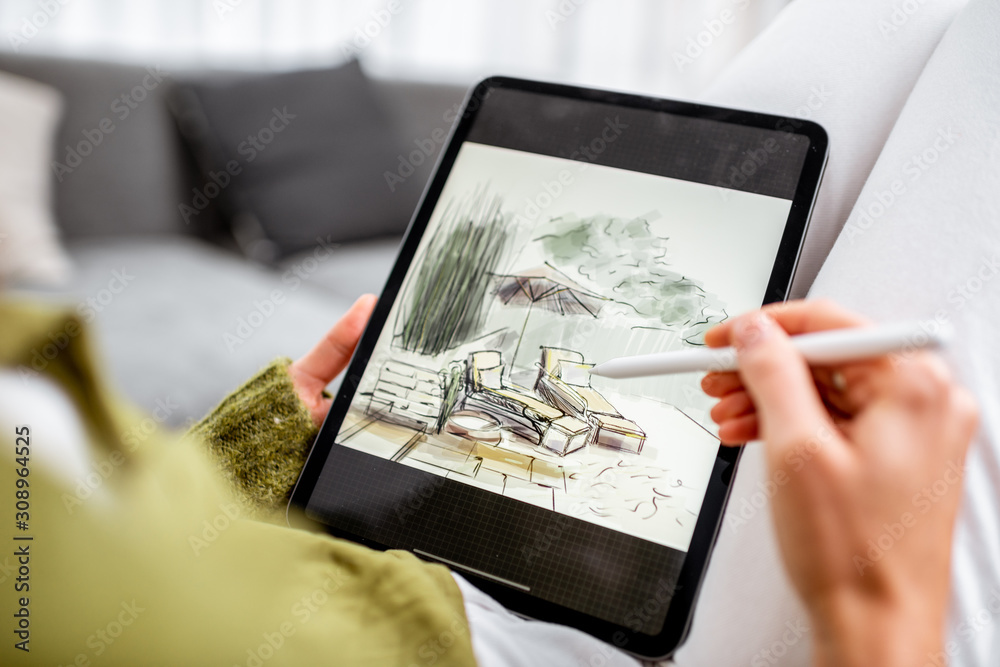 艺术家或设计师进行景观设计，用铅笔在数字平板电脑上画画，特写镜头