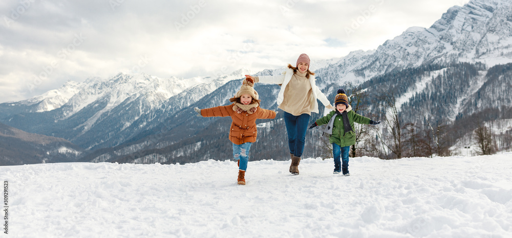 happy family mother and children having fun on winter walk.
