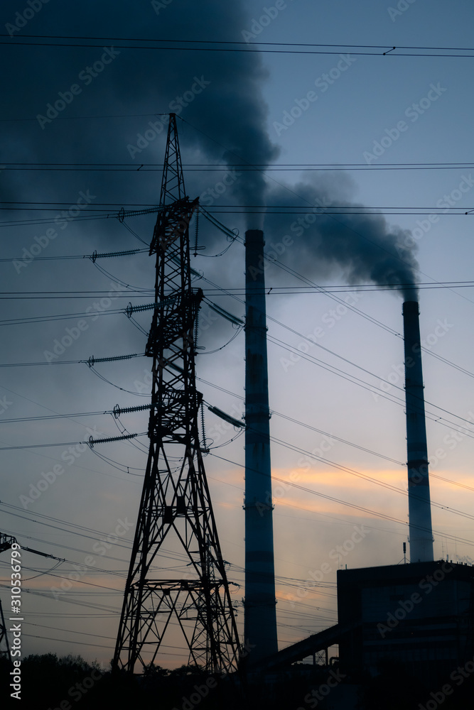 high voltage post. High-voltage tower sky background, factory pipe with smoke over it. Earth polluti
